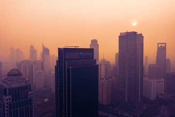 High buildings with air pollution at sunset