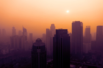 Fototapeta premium Jakarta cityscape covered by dust smog at sunset