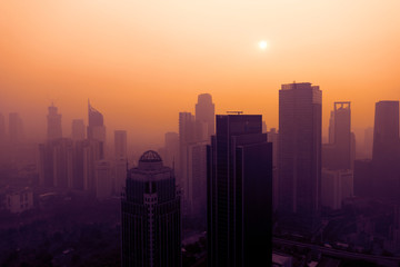 Jakarta cityscape covered by dust smog at sunset