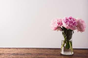 beautiful pink peony flowers bouquet in glass vase