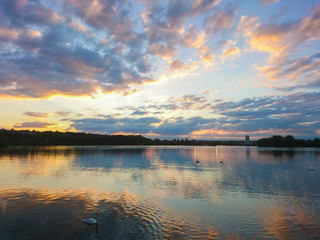 Beautiful seaside landscape with reflections of the sun at sunset. Symmetry of the colorful sky in the water. Cumulonimbus that pass over the horizon.