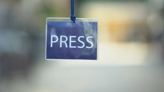 Press identification card against blurred background, privilege pass for media