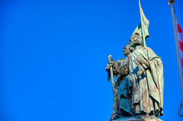 The Jan Breydel and Pieter de Coninck statue located in the historical city center and Market Square (Markt) in Bruges (Brugge), Belgium on a sunny day.