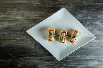 top view mini snacks with herring pieces and green onion