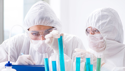 Two chemists working in the lab