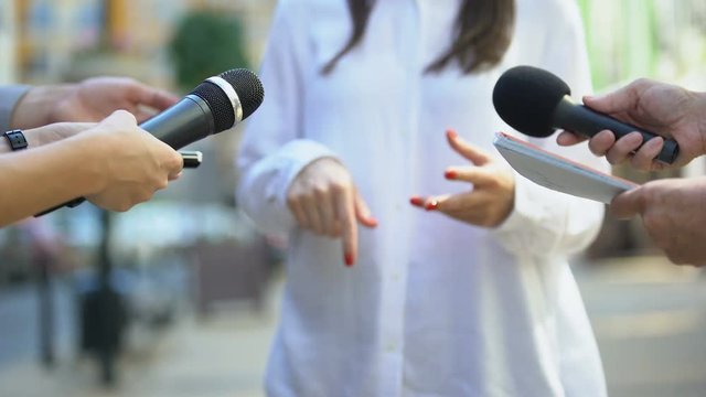 Female politician talking on media press conference, public relations, event