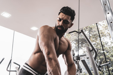 A man workout with Cable Triceps Pushdown in gym.