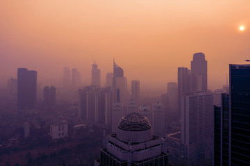 Fototapeta na wymiar Silhouette of high buildings with air pollution