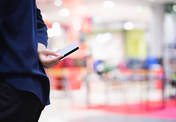 Portrait of happy Asian woman show a cradit card to shopping.
