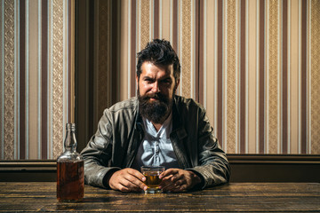 Handsome stylish bearded man is drinking at home after work. Drunk man. Stylish man.Portrait of man...