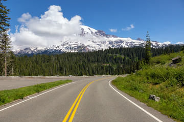 Beautiful view of a scenic road surrounded by the Mountain Landscape during a sunny summer day. Taken in Paradise, Mt Rainier National Park, Washington, United States of America.