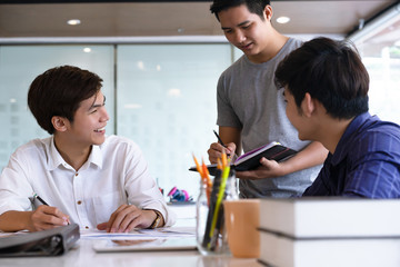 Diverse group of asia university students studying or working together at a university.