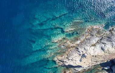Aerial view on underwater reefs in mediterranean sea with clear transparent water. Crete, Greece