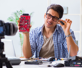 Vlogger recording computer repair on camera for vlog blog