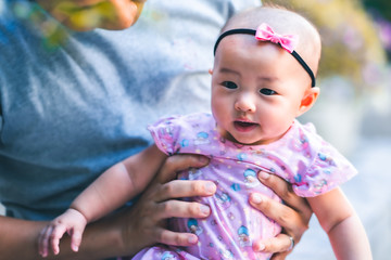 Asian baby happy in the graden.Asian baby girl happy family time.