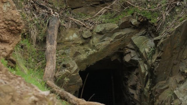 Tunnel carved into the rock face during the gold rush era. TILT DOWN