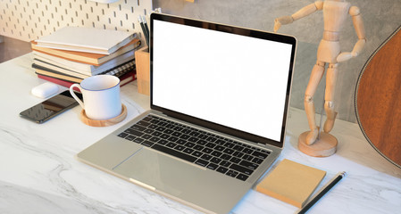Designer's work place with blank screen laptop