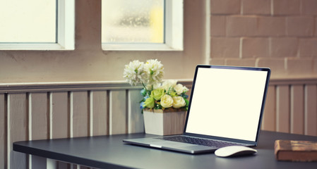 Blank screen laptop in modern comfortable work place