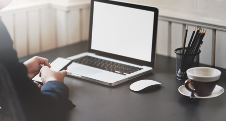 Businessman working on blank screen laptop
