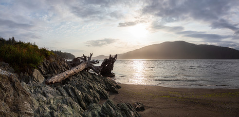 Beautiful Panoramic View of a beach in a small town during a cloudy summer sunset. Taken at Port Renfrew, Vancouver Island, BC, Canada.