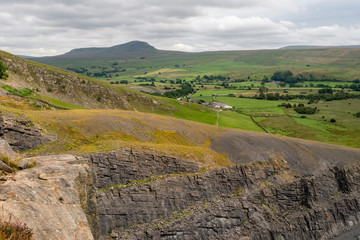 Moughton Scar is a vast and impressive limestone pavement full of interesting nooks and crannies. In the distance a moody Pen-y-ghent is seen in profile.