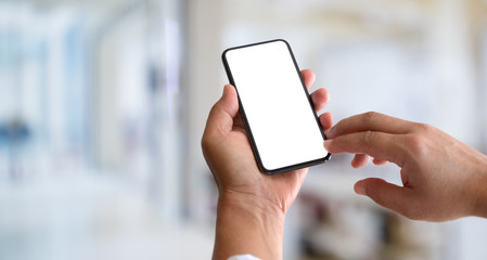 Cropped view of man's hands holding blank screen smartphone