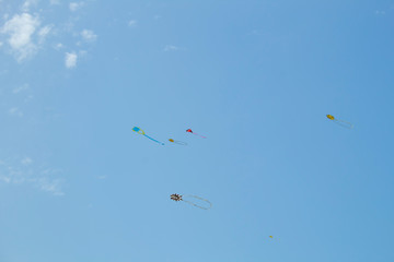 Kite floating in the blue sky with tasseled tail