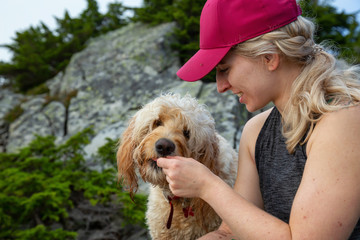 Adventurous Blonde Caucasian Woman Hiker is spending time with her Dog in the nature. Taken in West Vancouver, British Columbia, Canada.