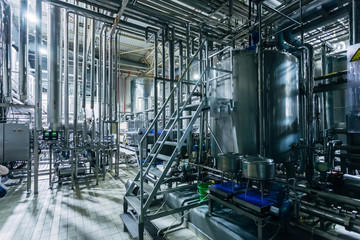 Modern brewery production steel vats connected by pipes