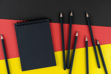 Blacklist Germany. Mourning, ban, sanctions, politics. black notebook and lot black pencils lies on...
