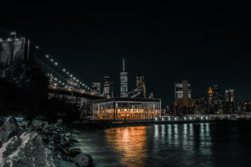 Fototapeta na wymiar Jane's Carousel with the Brooklyn Bridge at night