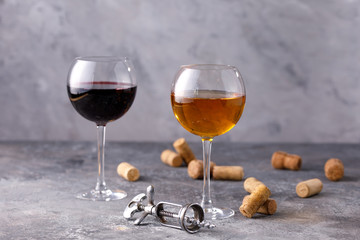 Glasses of white and red wine. The concept of winemaking. Place under your text. Still life on a textural background.
