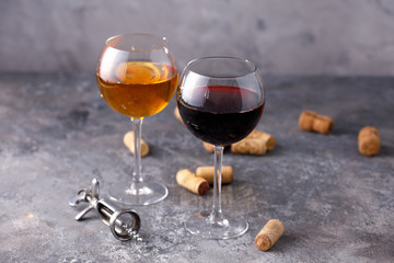 Glasses of white and red wine. The concept of winemaking. Place under your text. Still life on a textural background.