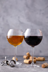 Glasses of white and red wine. The concept of winemaking. Place under your text. Still life on a textural background.