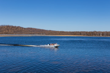 On the waters of the holiday lake, there are speedboats for tourists.