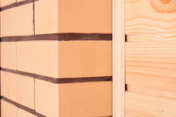 The combination of beige decorative brick with pine clapboard in the interior