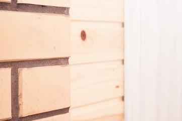 The combination of beige decorative brick with pine clapboard in the interior