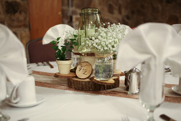 Wedding Photography Bridal Reception Table Centerpiece with Wood, Greenery, Candle in a Jar, and Baby's Breath