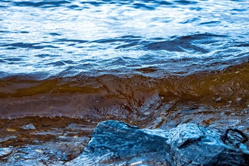 Wave rushing to the stone