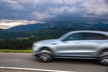 Fototapeta na wymiar a modern SUV riding a mountain road leading through a pass