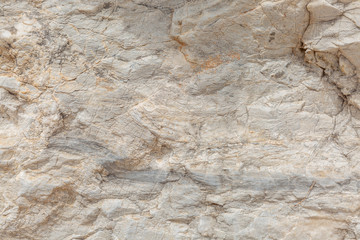 The texture of the surface of natural stone, close-up. Building material of ancient civilizations. Background. Spaces for text.