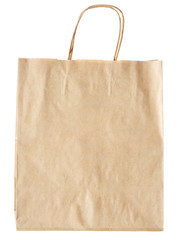 New empty blank paper bag with handles without inscriptions and logos. Made from brown kraft paper. Isolated on white background.
