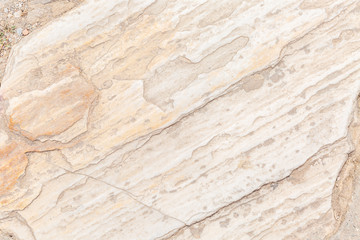 The texture of the surface of natural stone, close-up. Building material of ancient civilizations. Background. Spaces for text.