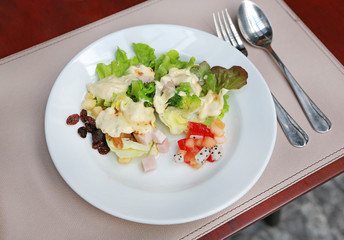 fresh vegetable salad in white plate on table