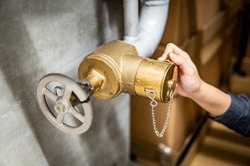 Male hand technician man checking water gate valve for hydrant system in factory by using digital...