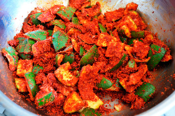 Raw mango pickle in a pan, mango pickle preparation.