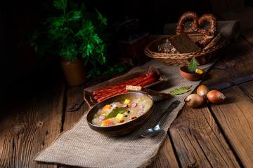 rustic sauerkraut soup with bacon and sausage