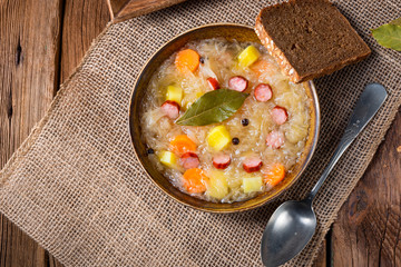 rustic sauerkraut soup with bacon and sausage