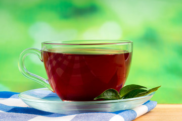 glass of tea on green background