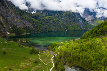 Scenic mountain panorama with green meadows and idyllic turquoise Lake Oberer